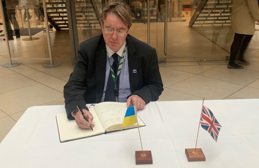 John signing book of solidarity